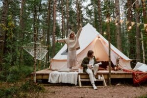 a couple in front of their glamping tent