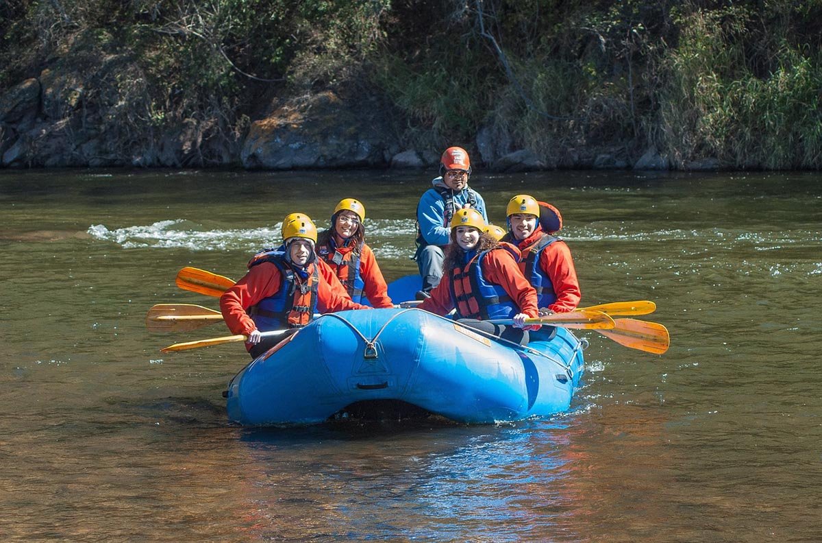 a family rafting practicing safe boating practices