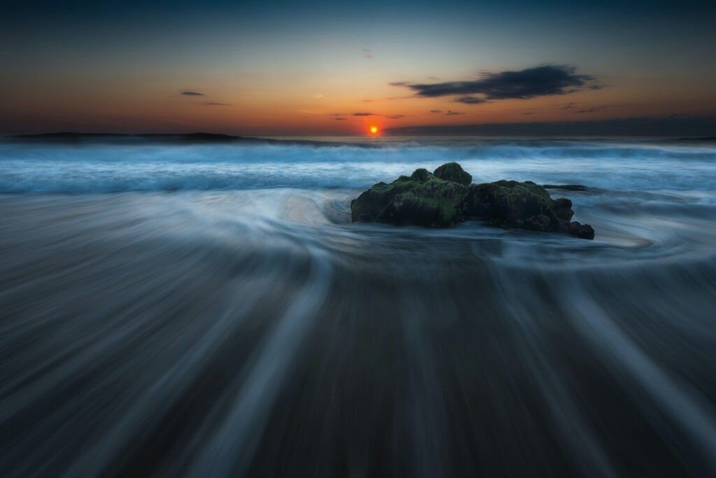 rocks at low tide and sunset